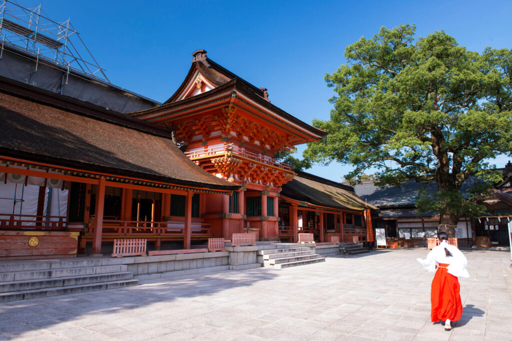 宇佐神宮 上宮の本殿全景と参道を歩く巫女の後ろ姿|八幡信仰発祥の地・国宝建築