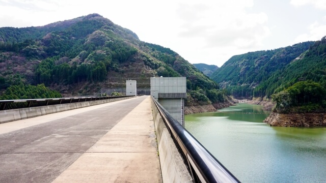 大山ダムの堤頂(ダムの最上部)から眼下に見下ろす、日田の大自然へと美しく続く阿蘇野川の流れ